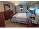 Cozy bedroom featuring wood furniture set and queen bed with patterned bedding and a ceiling fan at 5330 Rancho Ave, Sarasota, FL 34234