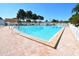 Large community pool surrounded by lounge chairs and palm trees, perfect for relaxation and recreation at 5330 Rancho Ave, Sarasota, FL 34234