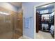 Bathroom with walk-in shower, towel rack, blue walls, and walk-in closet at 5814 Cavano Dr, Sarasota, FL 34231