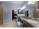 Bathroom with double sink vanity, walk-in shower, blue walls, and walk-in closet at 5814 Cavano Dr, Sarasota, FL 34231