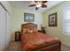 Cozy bedroom featuring decorative ceiling fan, neutral carpet, and decorative bedding at 5814 Cavano Dr, Sarasota, FL 34231