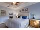 Bedroom features white bedding, soft blue walls, ceiling fan and furniture with ample lighting at 5814 Cavano Dr, Sarasota, FL 34231
