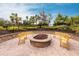 Inviting fire pit with comfortable seating, perfect for outdoor gatherings and enjoying the beautiful landscaping at 5814 Cavano Dr, Sarasota, FL 34231