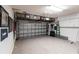 Spacious two-car garage featuring epoxy floors, overhead storage and plenty of storage cabinets at 5814 Cavano Dr, Sarasota, FL 34231