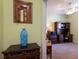 Home office with wooden desk, chair, shelving and blue vase on dark wood chest at 5814 Cavano Dr, Sarasota, FL 34231