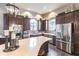 A stunning clubhouse kitchen showcases stainless steel appliances, dark wood cabinets and lots of counter space at 5814 Cavano Dr, Sarasota, FL 34231