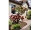 Charming landscaping featuring colorful plants and mushroom ornaments adorns the front of this inviting home at 5814 Cavano Dr, Sarasota, FL 34231