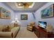 Comfortable living room with a ceiling fan, a plush sofa, an accent chair, and entertainment center at 5814 Cavano Dr, Sarasota, FL 34231