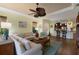 Bright living room with hardwood floors, ceiling fan, and an open floor plan to the kitchen at 5814 Cavano Dr, Sarasota, FL 34231