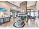 Clubhouse lobby showcasing a stone fireplace, chandelier, tile flooring, and cozy seating area at 5814 Cavano Dr, Sarasota, FL 34231