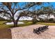 Brick patio with comfortable seating, overlooking a peaceful lake and expansive green space at 5814 Cavano Dr, Sarasota, FL 34231