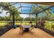 Screened-in patio features a table, chairs, and views of the pond, creating an inviting outdoor space at 5814 Cavano Dr, Sarasota, FL 34231
