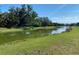Scenic view of the pond with lush greenery in the background, enhancing the property's appeal at 5814 Cavano Dr, Sarasota, FL 34231