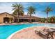 Beautiful community pool with lounge chairs under palm trees for ultimate relaxation by the water at 5814 Cavano Dr, Sarasota, FL 34231