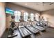Modern gym with several treadmills, elliptical machines, and large windows offering scenic views at 5814 Cavano Dr, Sarasota, FL 34231