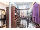 Spacious walk-in closet with custom wood shelving and organization system at 5814 Cavano Dr, Sarasota, FL 34231