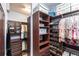 Beautiful walk-in closet with custom wood shelving and drawers at 5814 Cavano Dr, Sarasota, FL 34231