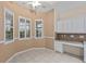 Inviting breakfast nook with shuttered windows, a ceiling fan, and built in desk with cabinets at 6211 Skyward Ct, Bradenton, FL 34203