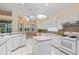 Well-lit kitchen with an island, white cabinetry, and a view from the windows at 6211 Skyward Ct, Bradenton, FL 34203