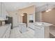 Bright kitchen featuring white cabinets, island, and modern appliances at 6211 Skyward Ct, Bradenton, FL 34203