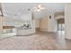 Open-concept living area with tile flooring, neutral decor, and view of kitchen at 6211 Skyward Ct, Bradenton, FL 34203