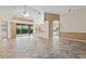 Spacious living space with open floor plan, tile flooring, and access to multiple rooms at 6211 Skyward Ct, Bradenton, FL 34203