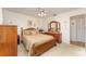 Warm bedroom featuring wood furniture, soft carpeting, and neutral tones for a relaxing ambiance at 6314 29Th W Ave, Bradenton, FL 34209