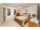 Traditional bedroom featuring wood furniture, ceiling fan, and bright natural light from a window at 6314 29Th W Ave, Bradenton, FL 34209
