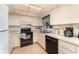 Functional kitchen featuring white cabinets, standard appliances, and ample counter space for meal preparation at 6314 29Th W Ave, Bradenton, FL 34209
