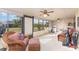 Enclosed sunroom featuring wicker furniture, a ceiling fan, and views of the outdoors at 6314 29Th W Ave, Bradenton, FL 34209