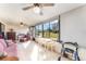 Sunroom with wicker furniture, ceiling fan, dining table, and large windows with views at 6314 29Th W Ave, Bradenton, FL 34209