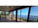 Bright enclosed porch offering amazing waterfront views through large sliding glass doors at 6430 Sun Eagle Ln # 201, Bradenton, FL 34210