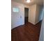 Inviting entrance with hardwood floors, white door, and a transom window providing natural light at 6430 Sun Eagle Ln # 201, Bradenton, FL 34210
