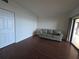 Neutral living room with hardwood floors, a comfortable sofa, and access to a screened porch at 6430 Sun Eagle Ln # 201, Bradenton, FL 34210