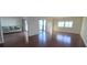 Spacious living room with hardwood floors and sliding glass doors to the balcony at 6430 Sun Eagle Ln # 201, Bradenton, FL 34210