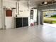 Clean and organized garage with a sealed floor, offering plenty of space for parking and storage solutions at 8995 Founders Cir, Palmetto, FL 34221