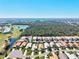 Scenic aerial showcasing homes, golf courses, lush greenery and cityscape in background at 1364 Berkshire Ct, Venice, FL 34292