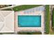 An aerial view of community pool with sun loungers and crystal clear waters surrounded by lush landscaping at 1364 Berkshire Ct, Venice, FL 34292