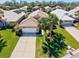 Aerial view of a residential neighborhood with well-kept lawns, tile roofs, and mature trees at 1364 Berkshire Ct, Venice, FL 34292