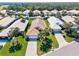 Aerial view showcasing the community's well-maintained lawns, landscaping, and uniform tile roofs at 1364 Berkshire Ct, Venice, FL 34292
