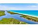 Breathtaking aerial view of the waterways, coastline and lush landscapes meeting the ocean at 1364 Berkshire Ct, Venice, FL 34292