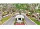 Welcoming community entrance surrounded by lush greenery, vibrant flowers, and a picturesque street at 1364 Berkshire Ct, Venice, FL 34292