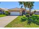 Beautifully landscaped home with a two-car garage and a meticulously maintained front yard at 1364 Berkshire Ct, Venice, FL 34292
