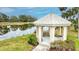 Idyllic gazebo nestled by a tranquil lake, offering a serene spot for relaxation and nature appreciation at 1364 Berkshire Ct, Venice, FL 34292