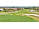 Community golf course aerial featuring manicured greens, a flag, sand trap and residences at 1364 Berkshire Ct, Venice, FL 34292