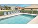 Relaxing community pool surrounded by meticulously manicured landscaping offering ample seating and shade at 1364 Berkshire Ct, Venice, FL 34292