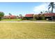 Manicured backyard featuring green lawn and lovely landscaping at 1430 57Th W St # 1430, Bradenton, FL 34209