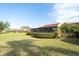View of backyard showing home with beautiful landscaping at 1430 57Th W St # 1430, Bradenton, FL 34209