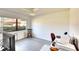 Bright bedroom with a large window, hardwood floors, and a ceiling fan, creating a comfortable workspace at 1430 57Th W St # 1430, Bradenton, FL 34209