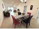 Inviting dining area adjacent to living room with glass table and bright, stylish decor at 1430 57Th W St # 1430, Bradenton, FL 34209